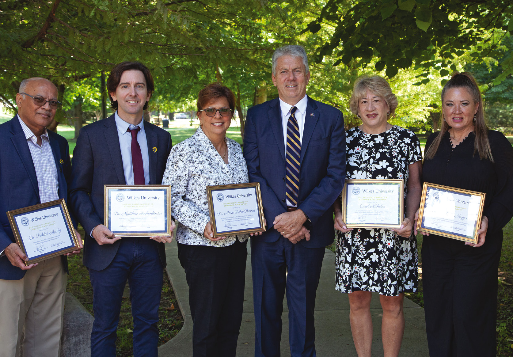Wilkes recipients of President's Award From left, Prahlad Murthy, professor of environmental engineering; Matthew Finkenbinder, associate professor of geology; Marie Roke-Thomas, associate professor of pharmaceutical sciences; Wilkes University President Greg Cant; Carol Nicholas, director of the SHINE program; and Kimberly Niezgoda, director of the English Language Center. Absent from photo is Don Mencer, professor of chemistry.
