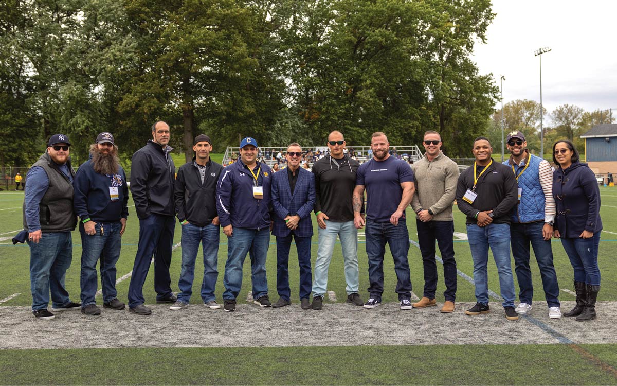Members of the 2006 football team gathered on the field with Rick Mahonski '77 and Gina Stefanelli '11.