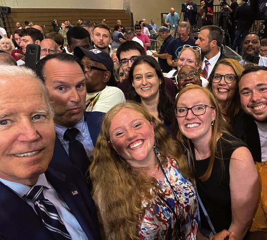 Gina Cherundolo of the Farley Library (with brown hair in center) with President Biden