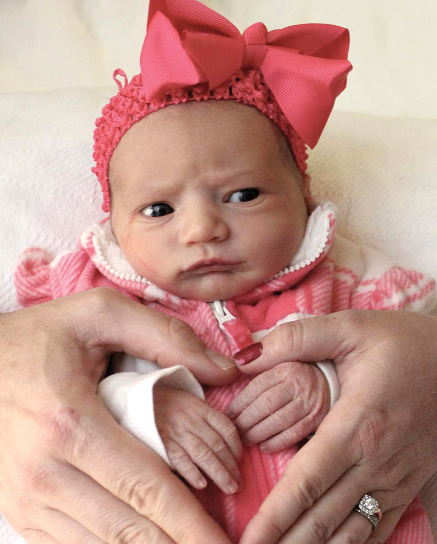 Close-up view of newborn daughter Natalina "Nina" in a pink onesie outfit and pink bowtie accessory around her head; She belongs to Edward T. Bednarz, III and his wife Heather (Jessup, Pa.)