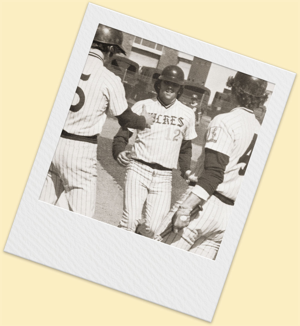 black and white photo of Don McDermott being greeted at home plate after hitting a home run