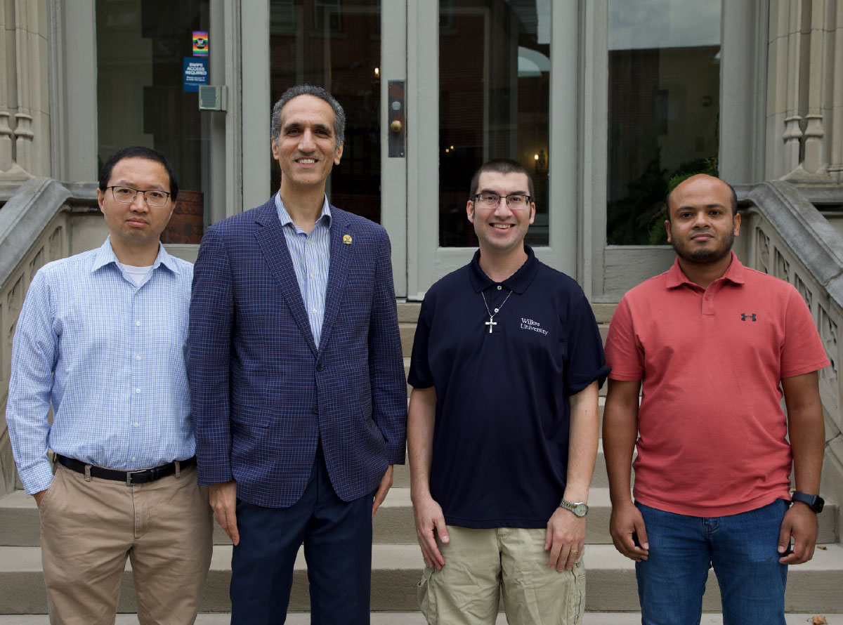 Four faculty members standing on stone steps for the National Science Foundation grant announcement.
