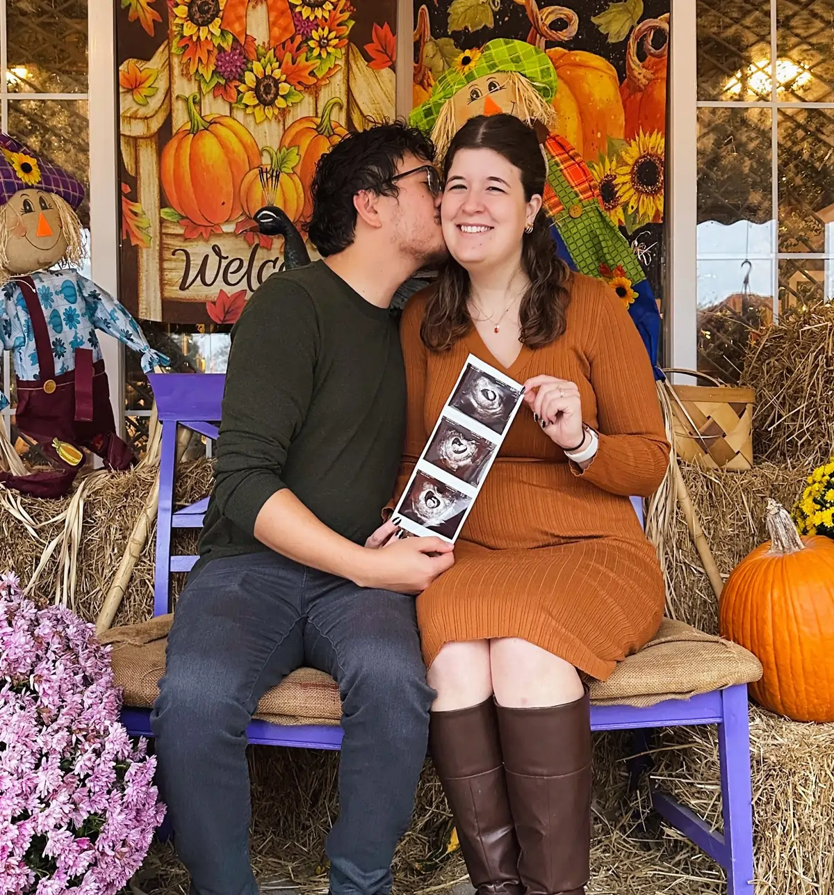 Nicole (Olver) Hagan and Joshua Hagan '18 as Joshua kisses Nicole's cheek while they hold a prenatal ultrasound scan of their upcoming child together